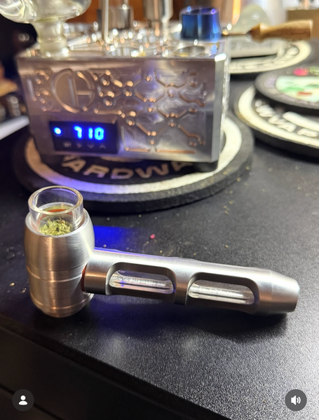 Airstream shown on desk with haze pipe in the foreground on desk | Cannabis Hardware