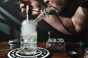 Flowerpot in use with a glass rig on a desk surrounded by accessories | Cannabis Hardware