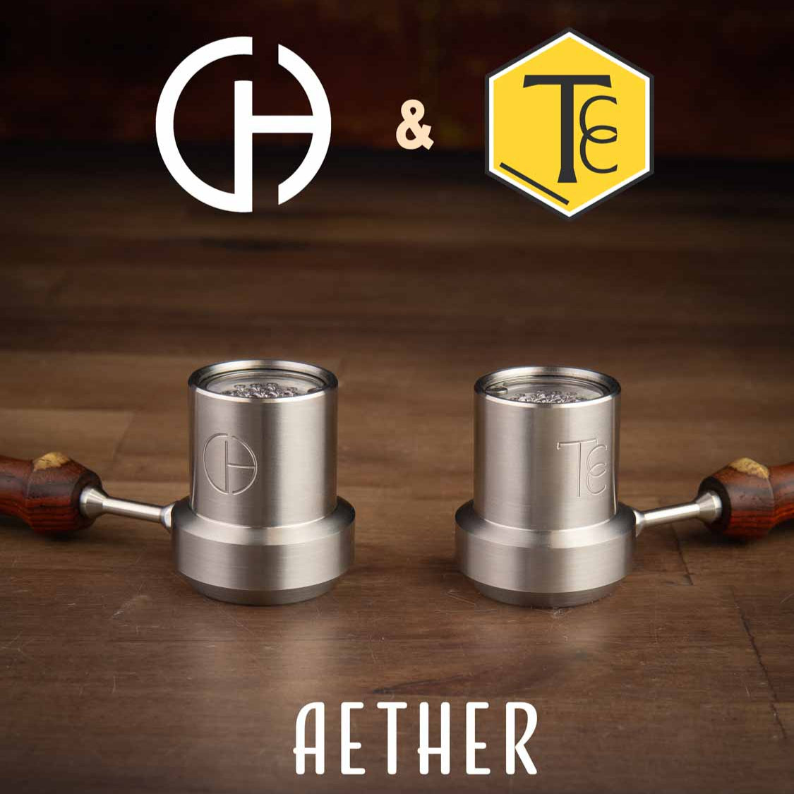 Two metal ball vapes on a wooden surface with 'Aether' branding and two logos above.